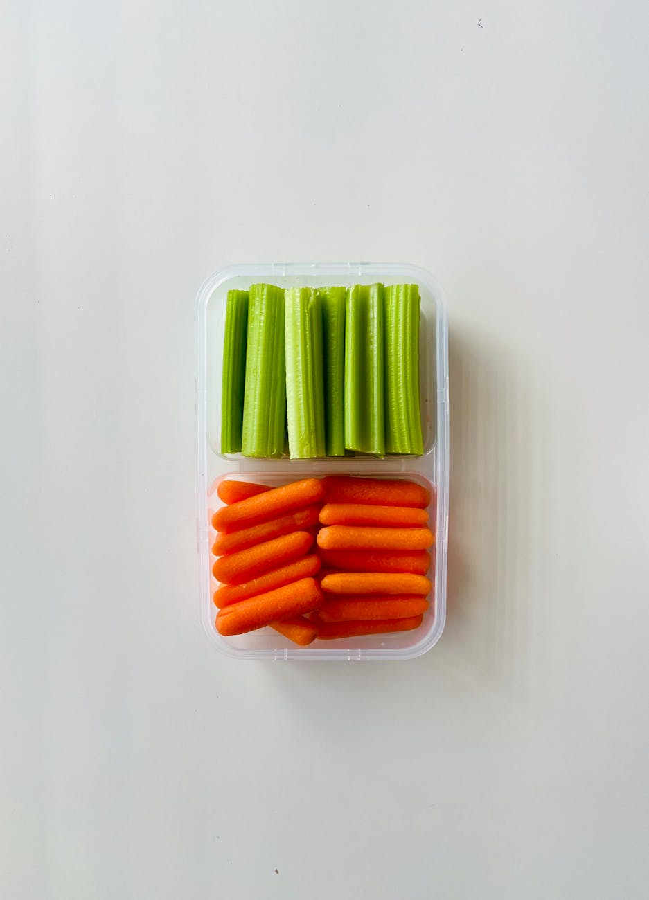 slices of carrots and celery in a plastic container