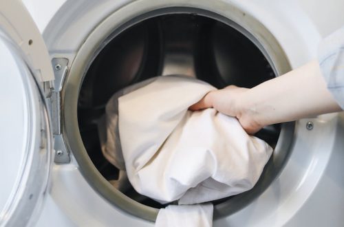 a person putting clothes in a washing machine